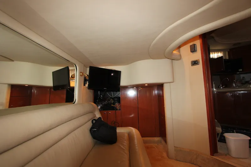 Slide: The Image of Interior of 2001 Sea Ray Sundancer 460 yacht with beige seating and mounted TV. - 14