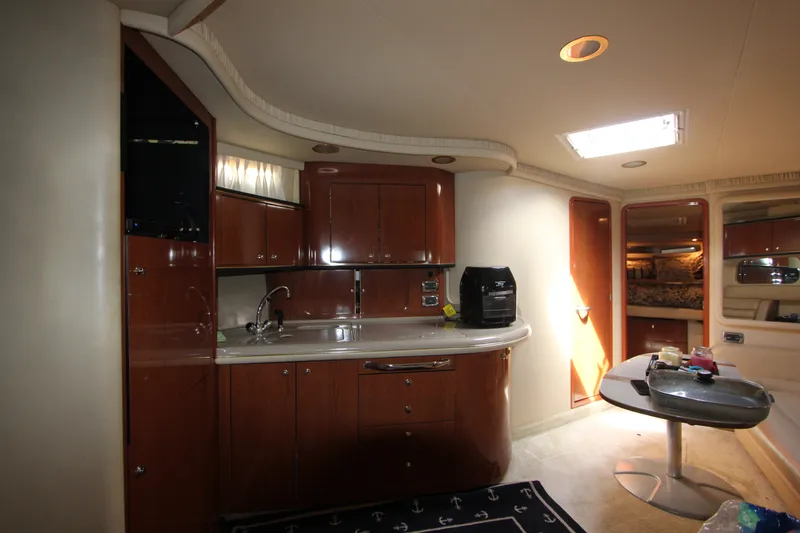 Slide: The Image of Interior of 2001 Sea Ray Sundancer 460 yacht with modern kitchen and cozy seating area. - 15