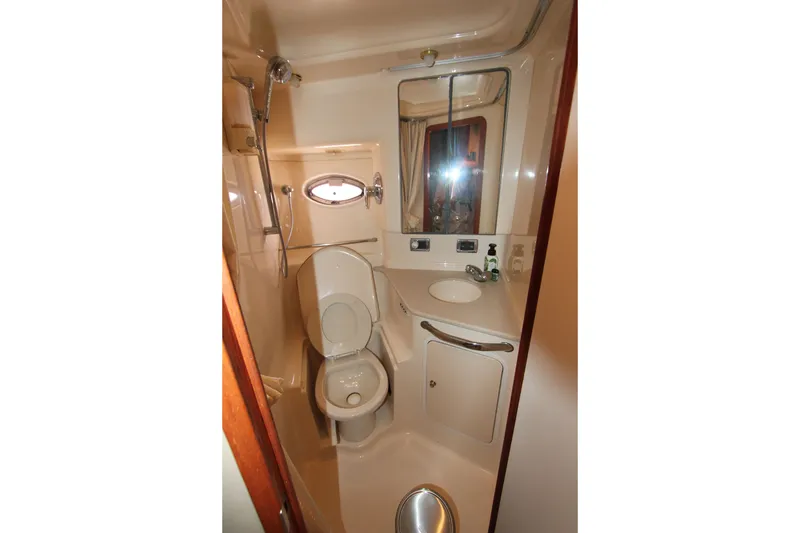 Slide: The Image of Bathroom interior of 2001 Sea Ray Sundancer 460 yacht, featuring toilet, sink, and shower. - 21