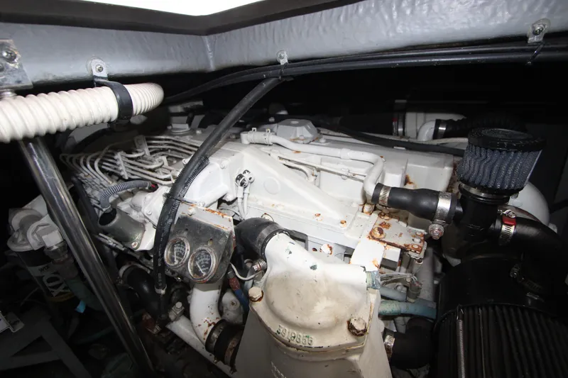 Slide: The Image of Engine compartment of a 2001 Sea Ray Sundancer 460, showcasing mechanical components and hoses. - 25