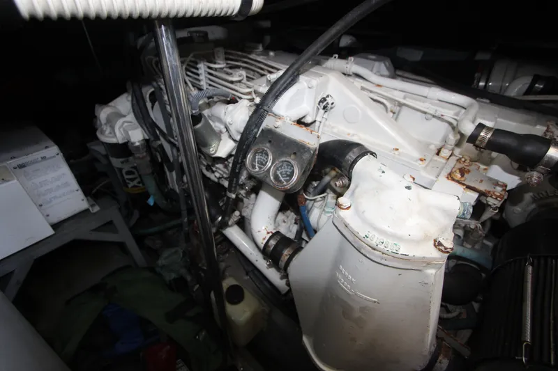 Slide: The Image of Engine compartment of a 2001 Sea Ray Sundancer 460, showing mechanical components and gauges. - 26