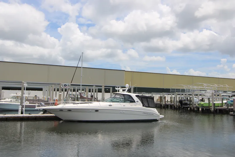 Slide: The Image of 2001 Sea Ray Sundancer 460 yacht docked at marina under cloudy sky. - 1