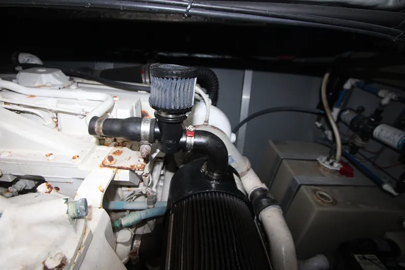 Slide: The Image of Engine compartment of a 2001 Sea Ray Sundancer 460, showing mechanical components and hoses. - 27