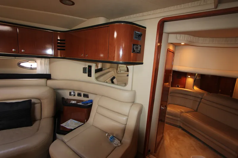 Slide: The Image of Interior of 2001 Sea Ray Sundancer 460 yacht with beige leather seating and wooden cabinetry. - 12