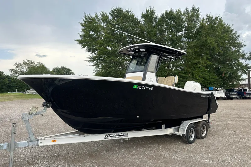 Slide: The Image of 2026 Sportsman Open 232 Center Console boat on trailer, parked outdoors. - 3
