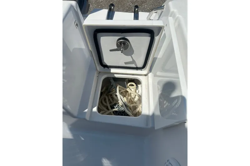 Slide: The Image of Open storage compartment on 2026 Sportsman Open 232 Center Console boat with ropes inside. - 22