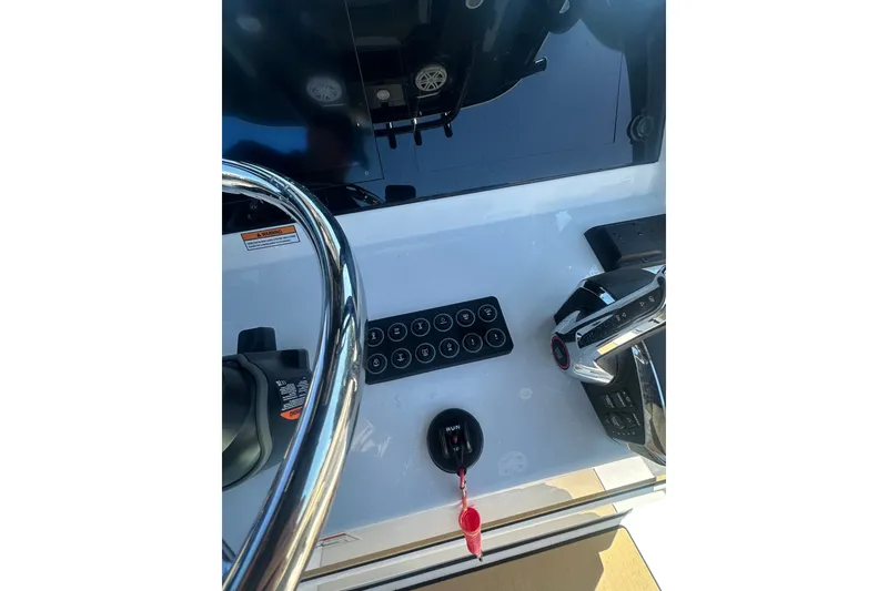 Slide: The Image of 2026 Sportsman Open 232 Center Console dashboard with steering wheel and controls. - 33