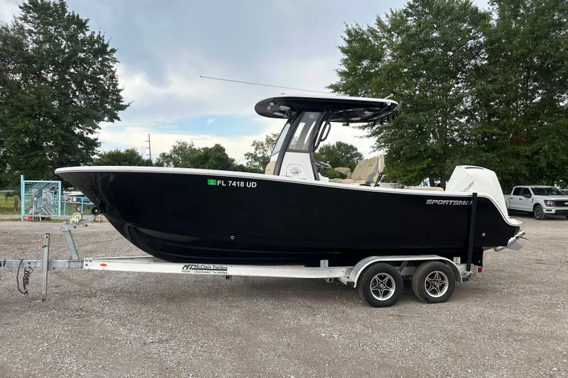 Slide: The Image of 2026 Sportsman Open 232 Center Console boat on trailer, parked outdoors. - 4