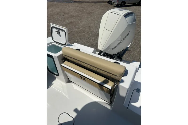 Slide: The Image of 2026 Sportsman Open 232 Center Console boat with Mercury engine and tan seating. - 6