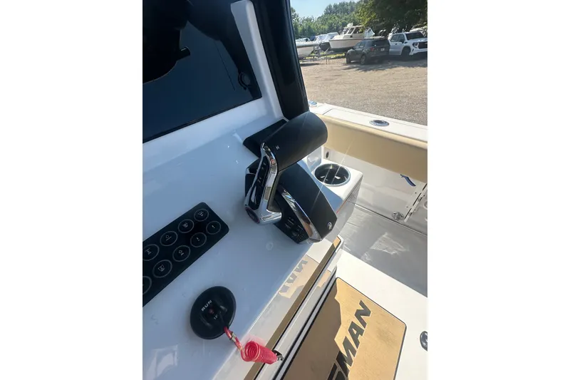 Slide: The Image of 2026 Sportsman Open 232 Center Console boat dashboard with controls and cup holder. - 34