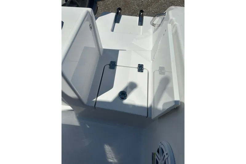Slide: The Image of 2026 Sportsman Open 232 Center Console boat deck with storage compartment and speaker. - 21