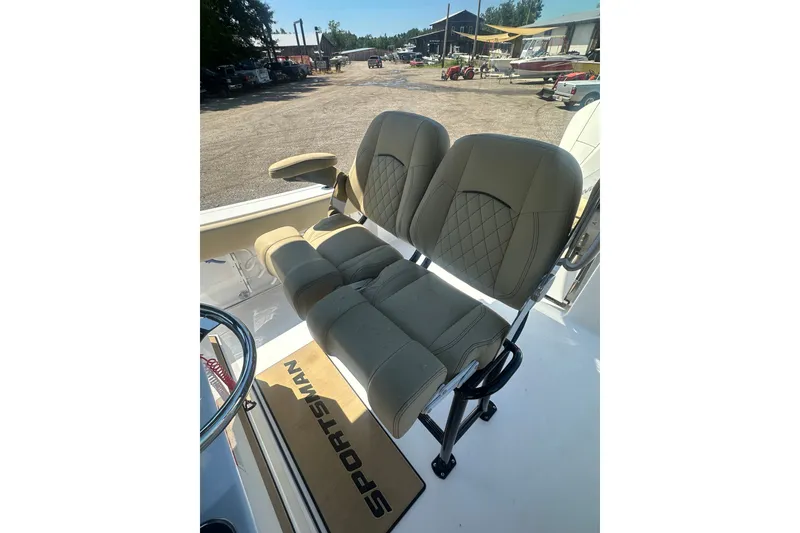 Slide: The Image of 2026 Sportsman Open 232 Center Console boat seats with diamond stitching and armrest. - 16