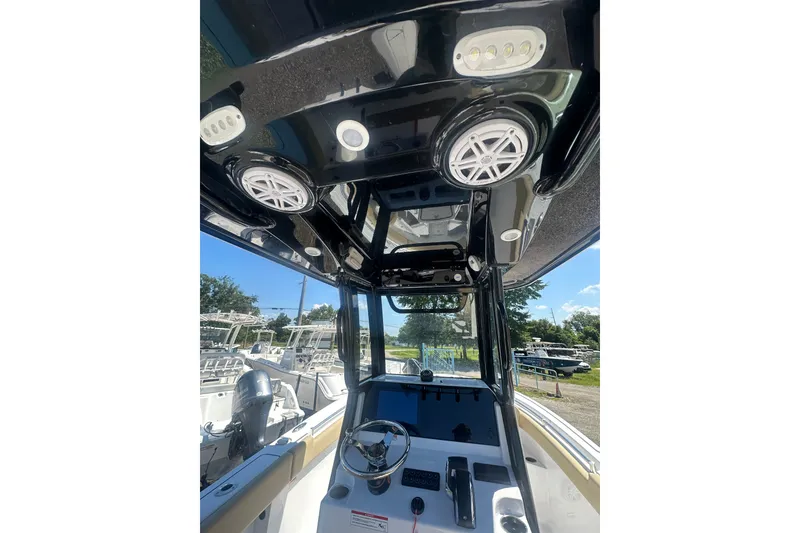 Slide: The Image of 2026 Sportsman Open 232 Center Console boat interior with modern controls and speakers. - 14