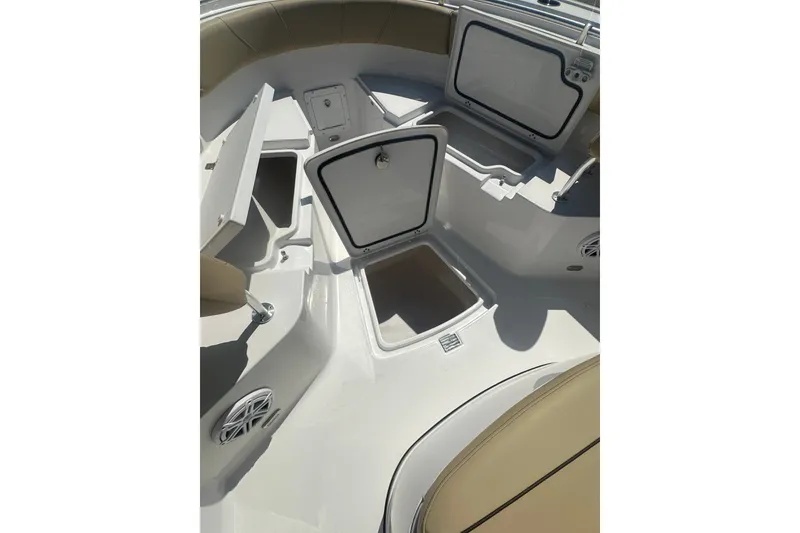 Slide: The Image of 2026 Sportsman Open 232 Center Console boat storage compartments and seating area. - 18