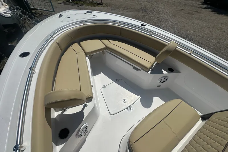 Slide: The Image of 2026 Sportsman Open 232 Center Console boat with tan seating and spacious deck layout. - 25