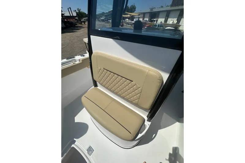 Slide: The Image of 2026 Sportsman Open 232 Center Console boat seat with beige upholstery and diamond stitching. - 24