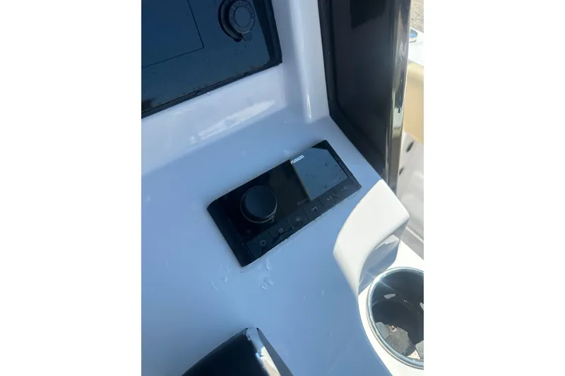 Slide: The Image of Control panel of 2026 Sportsman Open 232 Center Console boat with Fusion audio system. - 28