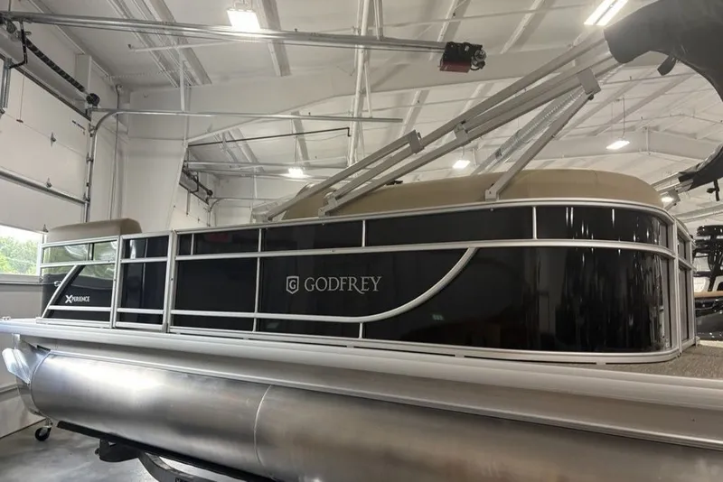 Slide: The Image of 2027 Godfrey XPERIENCE 2086 pontoon boat in a well-lit garage. - 5