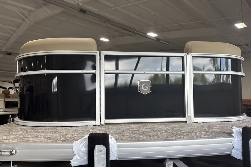 Slide: The Image of 2027 Godfrey XPERIENCE 2086 pontoon boat in showroom, featuring sleek black exterior. - 4