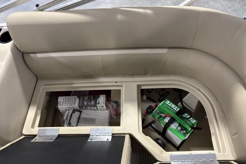 Slide: The Image of Storage compartment in a 2027 Godfrey XPERIENCE 2086 boat with battery and supplies. - 17