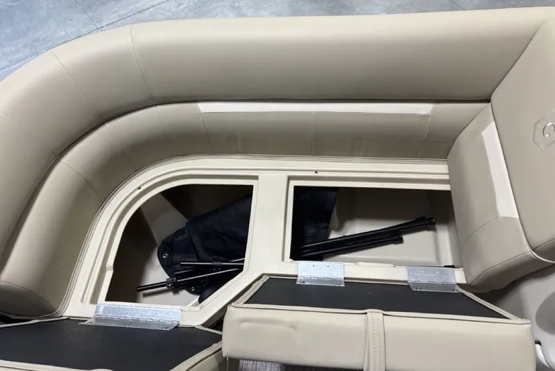 Slide: The Image of 2027 Godfrey XPERIENCE 2086 boat interior storage compartment with beige seating. - 10