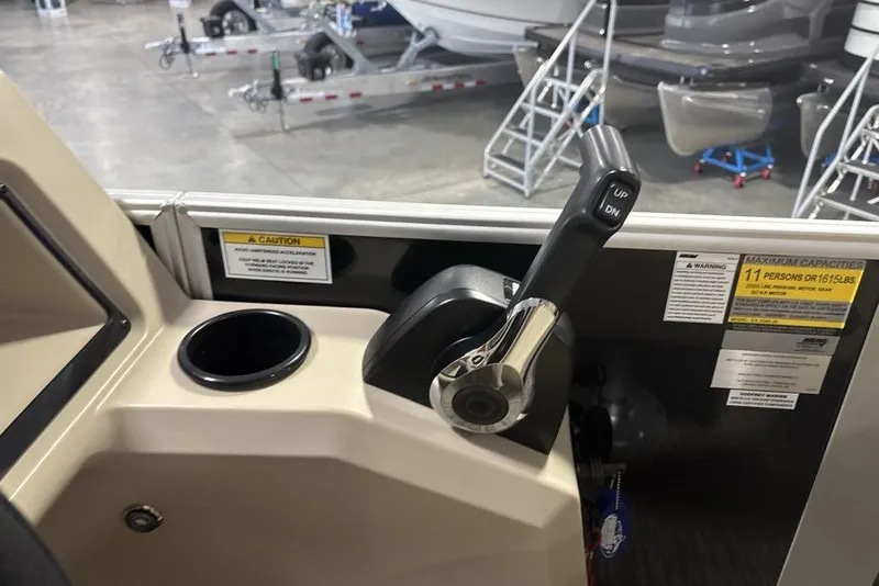 Slide: The Image of Control panel of 2027 Godfrey XPERIENCE 2086 boat with throttle lever and cup holder. - 8