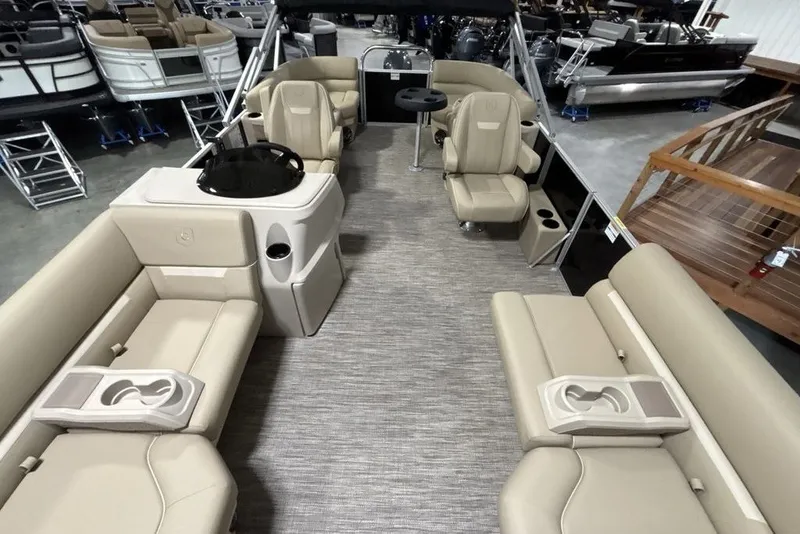 Slide: The Image of 2027 Godfrey XPERIENCE 2086 pontoon boat interior with beige seating and helm. - 21