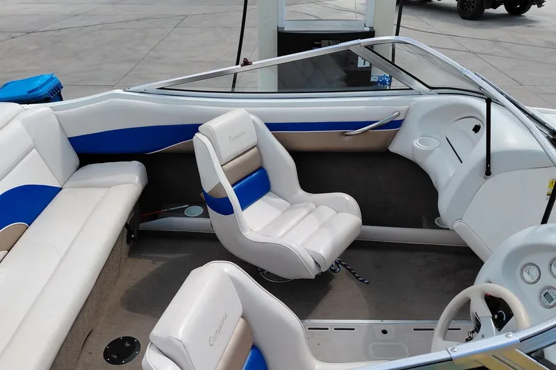 Slide: The Image of Interior of a 1999 Ebbtide Campione 190 boat with white and blue seating. - 8