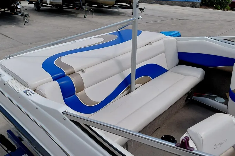 Slide: The Image of 1999 Ebbtide Campione 190 boat interior with blue and beige seating design. - 9