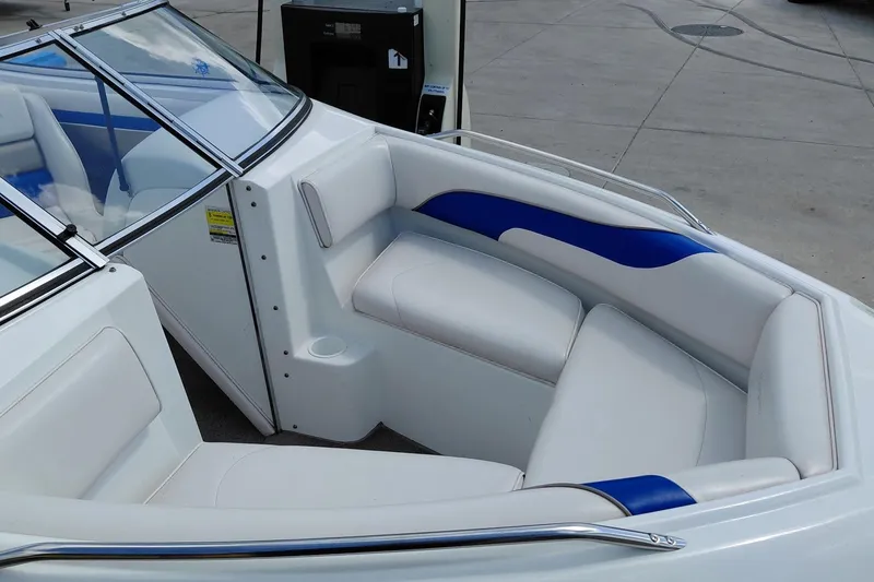 Slide: The Image of 1999 Ebbtide Campione 190 boat interior with white and blue seating. - 10