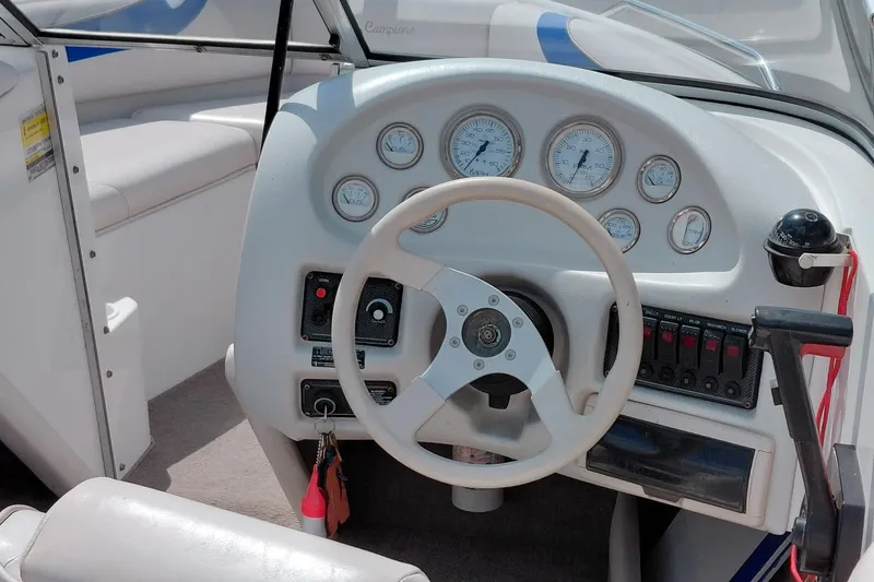 Slide: The Image of 1999 Ebbtide Campione 190 boat dashboard with steering wheel and gauges. - 6