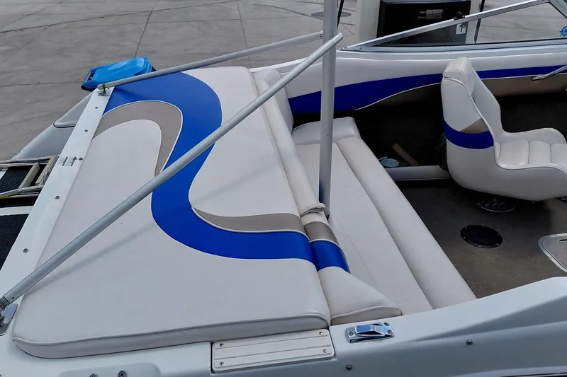 Slide: The Image of 1999 Ebbtide Campione 190 boat interior with blue and beige seating design. - 7