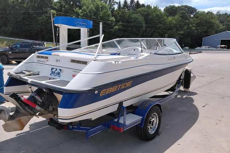 Slide: The Image of 1999 Ebbtide Campione 190 boat on trailer at a marina, sunny day. - 3
