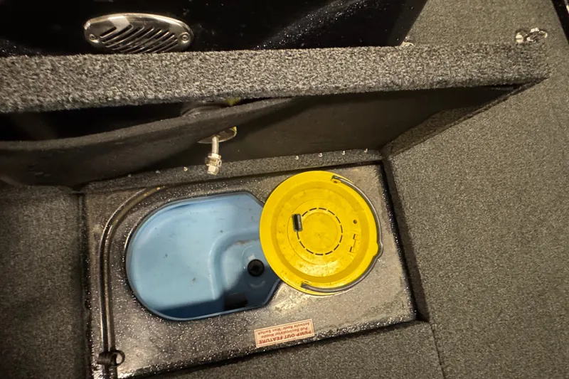Slide: The Image of Livewell compartment in a 2021 Nitro ZV19 Sport boat with yellow lid and blue interior. - 19