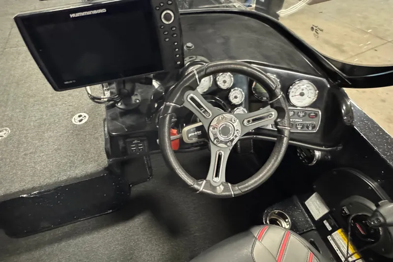 Slide: The Image of 2021 Nitro ZV19 Sport boat dashboard with steering wheel and electronic display. - 7