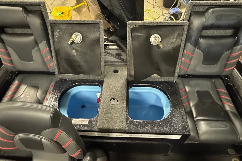 Slide: The Image of 2021 Nitro ZV19 Sport boat interior with open storage compartments and seating. - 12