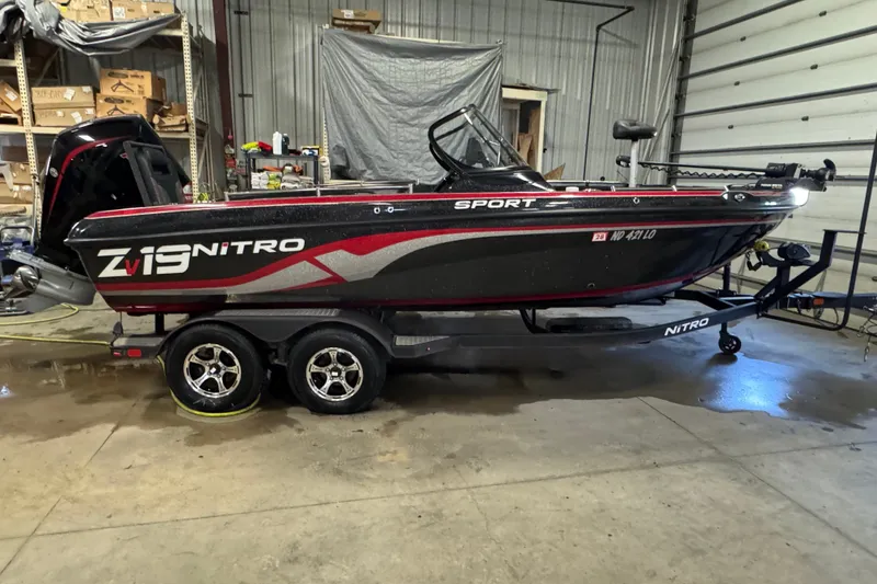 The Image of 2021 Nitro ZV19 Sport boat in a garage, on a trailer, side view. - 0
