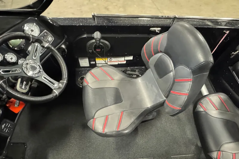 Slide: The Image of Interior of 2021 Nitro ZV19 Sport boat with steering wheel and cushioned seats. - 8