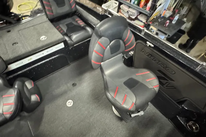 Slide: The Image of Interior of 2021 Nitro ZV19 Sport boat with black and red seating. - 11