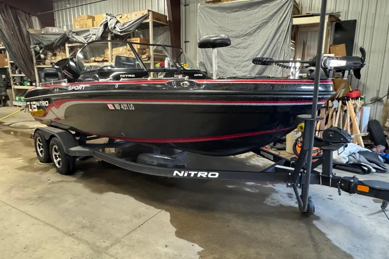 Slide: The Image of 2021 Nitro ZV19 Sport boat on trailer in a garage setting. - 2