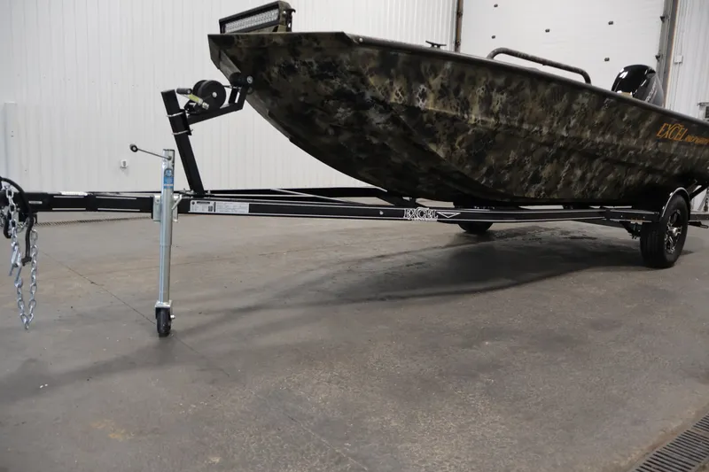 Slide: The Image of 2025 Excel 1651 River Warrior SC boat on trailer in indoor setting. - 28