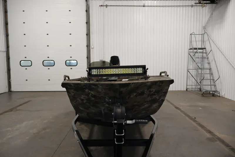 Slide: The Image of 2025 Excel 1651 River Warrior SC boat in a garage setting. - 2