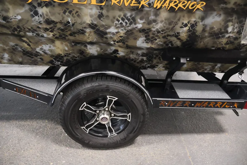 Slide: The Image of 2025 Excel 1651 River Warrior SC trailer with camouflage design and black alloy wheel. - 29