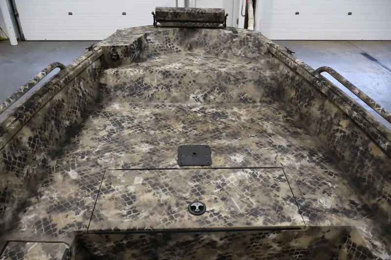 Slide: The Image of 2025 Excel 1651 River Warrior SC boat interior with camouflage pattern in a garage setting. - 12