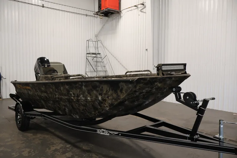 Slide: The Image of 2025 Excel 1651 River Warrior SC boat on trailer in indoor setting. - 3