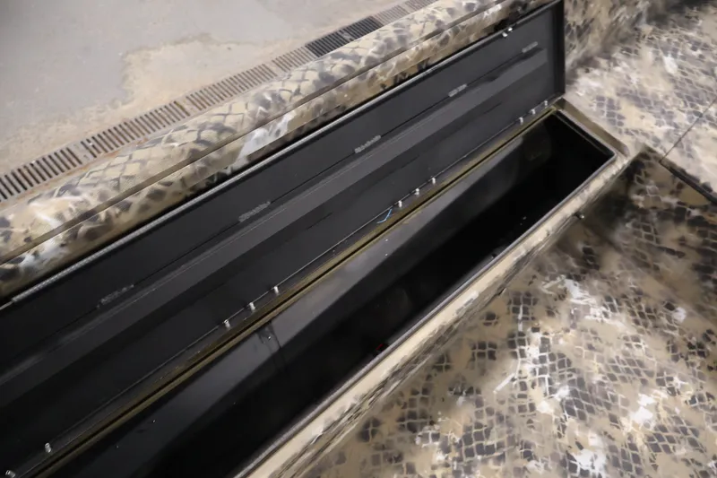 Slide: The Image of 2025 Excel 1651 River Warrior SC boat interior with camo pattern and open storage compartment. - 21