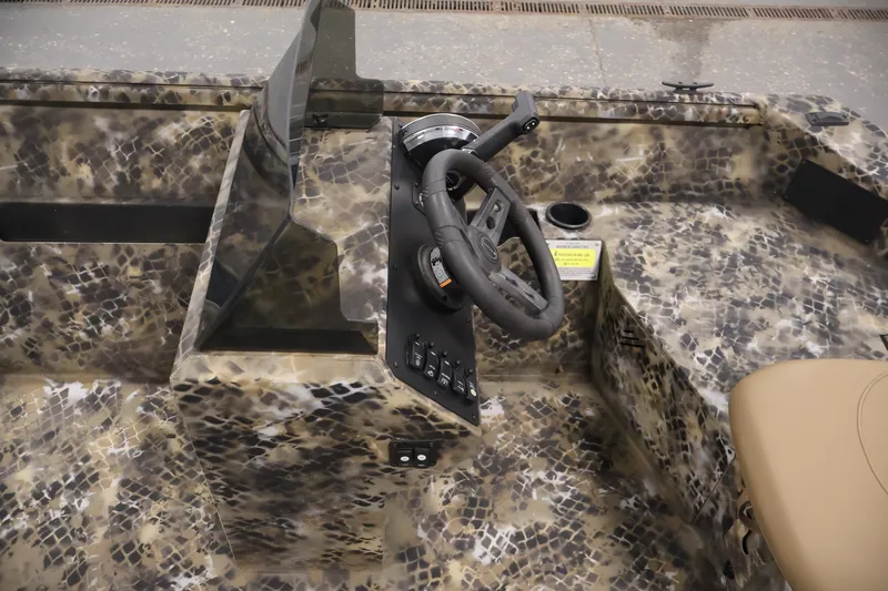 Slide: The Image of 2025 Excel 1651 River Warrior SC boat interior with camouflage design and steering console. - 14