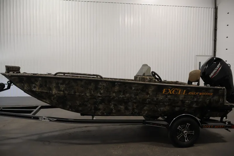 Slide: The Image of 2025 Excel 1651 River Warrior SC boat with camouflage design and Mercury outboard motor. - 8