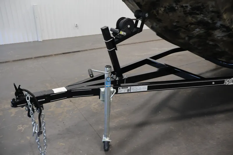 Slide: The Image of Trailer hitch of 2025 Excel 1651 River Warrior SC boat, featuring sturdy chains and wheel jack. - 27