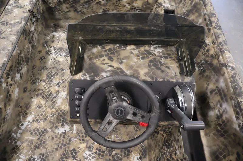 Slide: The Image of 2025 Excel 1651 River Warrior SC boat dashboard with camouflage design and steering wheel. - 15
